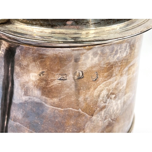 707 - A mid Georgian hallmarked silver quart tankard of ribbed cylindrical form, with hinged lid and swell... 