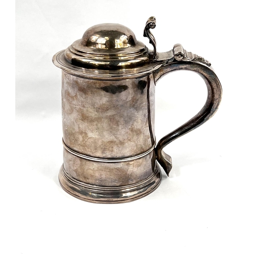 708 - An early Georgian hallmarked silver quart tankard of ribbed cylindrical form, with domed hinged lid ...