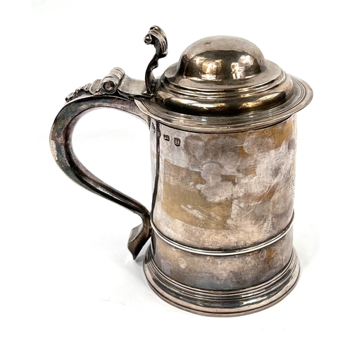 708 - An early Georgian hallmarked silver quart tankard of ribbed cylindrical form, with domed hinged lid ... 