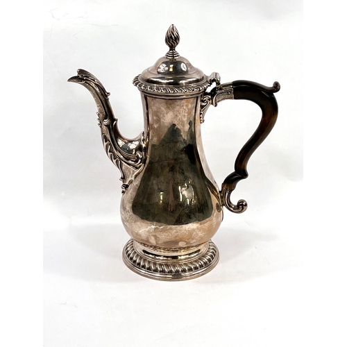 709 - A Georgian hallmarked silver baluster coffee pot with gadrooned rim and circular foot, acanthus leav... 