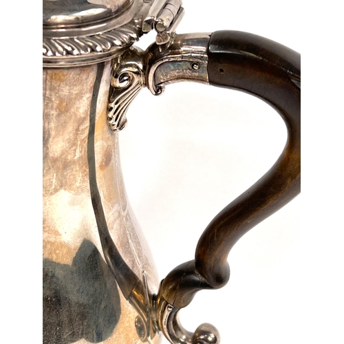 709 - A Georgian hallmarked silver baluster coffee pot with gadrooned rim and circular foot, acanthus leav... 