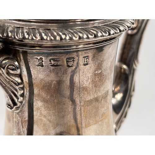 709 - A Georgian hallmarked silver baluster coffee pot with gadrooned rim and circular foot, acanthus leav... 