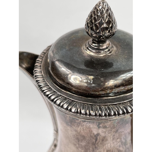 710 - A Georgian hallmarked silver baluster coffee pot with pineapple finial, gadrooned rim, reeded spout,... 