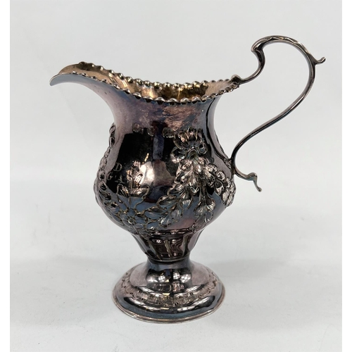 714 - A Georgian hallmarked silver baluster cream jug on pedestal base with embossed swags, London 1773, 3... 