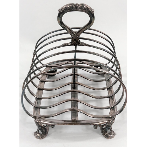 721 - A hallmarked silver 6 division toast rack with kidney shaped dividers with central ring handle, on 4... 