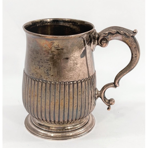 722 - A hallmarked silver baluster half pint mug with reeded lower body, on circular foot, inscribed to ba... 