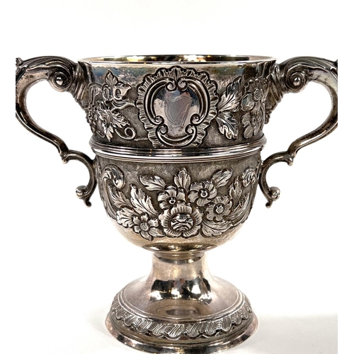 731 - A hallmarked silver pair of Irish cast loving cups with twin handles, extensive relief decoration of... 