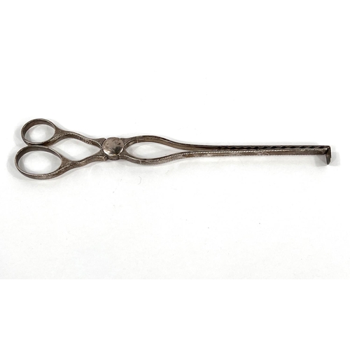 745 - An 18th century hallmarked silver pair of asparagus tongs, scissor shaped, the edges with incised de... 