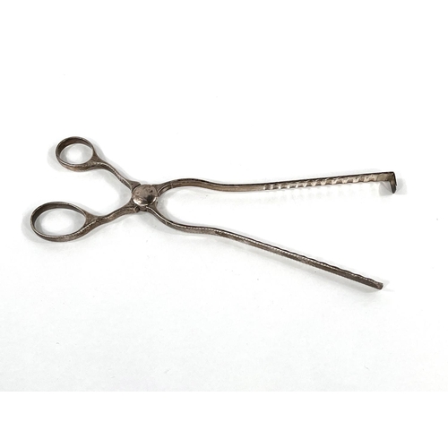 745 - An 18th century hallmarked silver pair of asparagus tongs, scissor shaped, the edges with incised de... 