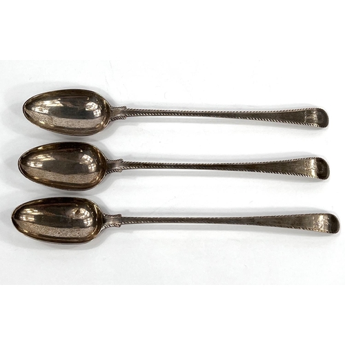 747 - A set of three silver basting spoons, feather banded, Old English bottom marked, 2 decorated with fi... 