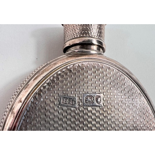 771 - A silver hip flask and stirrup cup with engine turned decoration and circular crest 'Suum Cuique' wi... 