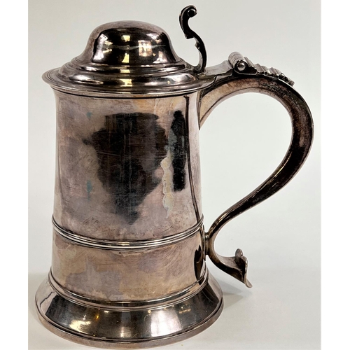 772 - An 18th century silver tankard with domed hinge lid, shaped handle with heart shaped scrolling termi... 