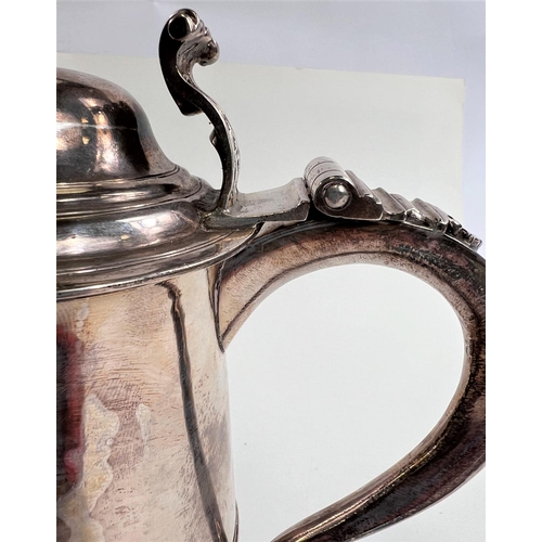 772 - An 18th century silver tankard with domed hinge lid, shaped handle with heart shaped scrolling termi... 