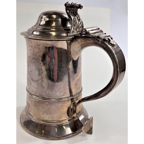 772 - An 18th century silver tankard with domed hinge lid, shaped handle with heart shaped scrolling termi... 