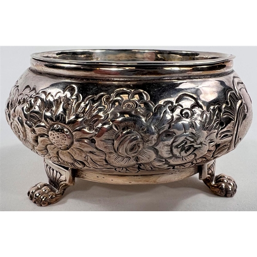 787 - A pair of early 19th century Irish silver salts, repousse decoration with parcel gilt interiors, car... 