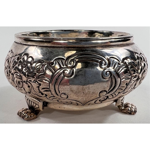 787 - A pair of early 19th century Irish silver salts, repousse decoration with parcel gilt interiors, car... 