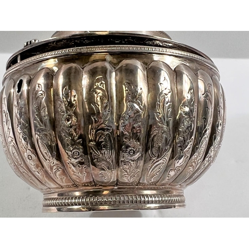 789 - A George III silver tea caddy of melon form, engraved decoration, waisted domed lid with figural fin... 