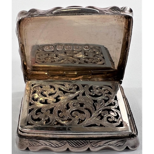 806 - A Victorian parcel gilt silver vinaigrette of waisted rectangular form, engraved leaf decoration, Bi... 