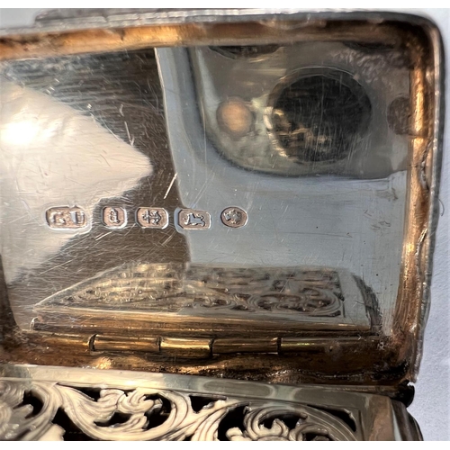 806 - A Victorian parcel gilt silver vinaigrette of waisted rectangular form, engraved leaf decoration, Bi... 