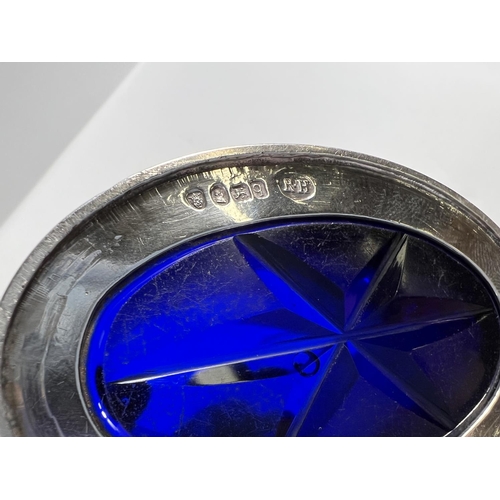 810 - A George III silver Adam style mustard pot of plain oval form, blue glass liner with star cut base, ... 