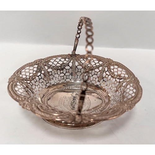 811 - A George III silver pedestal basket with swing handle, pierced latticework with raised sway decorati... 