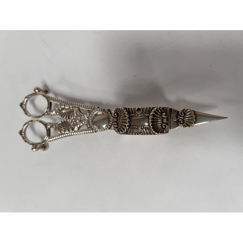 817 - An early 19th century silver candle snuffer with cast shell decoration, tray with gadrooned border, ... 