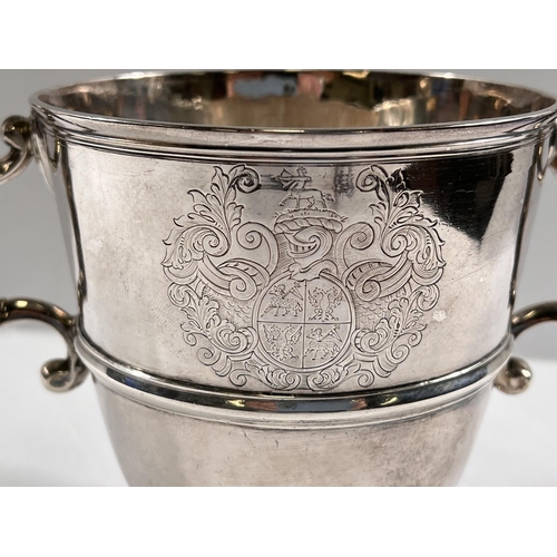 818 - An early 18th century IRISH silver two handled pedestal cup of tapering form with central raised ban... 