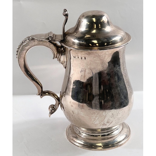 821 - An 18th century IRISH silver THREE PINT covered tankard of baluster form with domed lid having acant... 