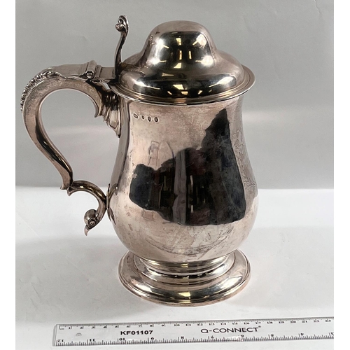 821 - An 18th century IRISH silver THREE PINT covered tankard of baluster form with domed lid having acant... 