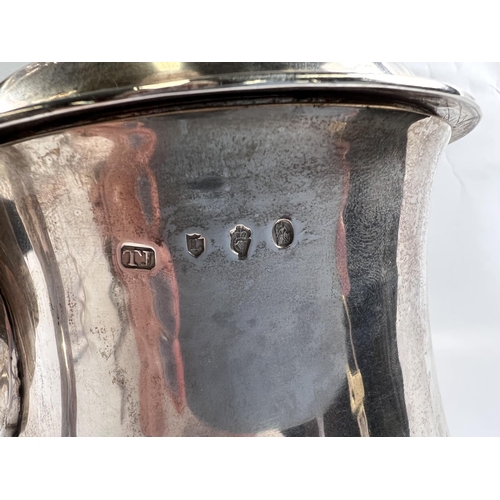 821 - An 18th century IRISH silver THREE PINT covered tankard of baluster form with domed lid having acant... 