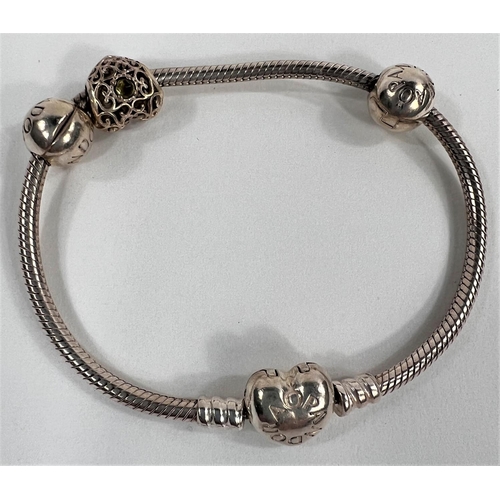 824 - A PANDORA silver bracelet with heart fastener and filigree silver charm; a white metal pendant with ... 