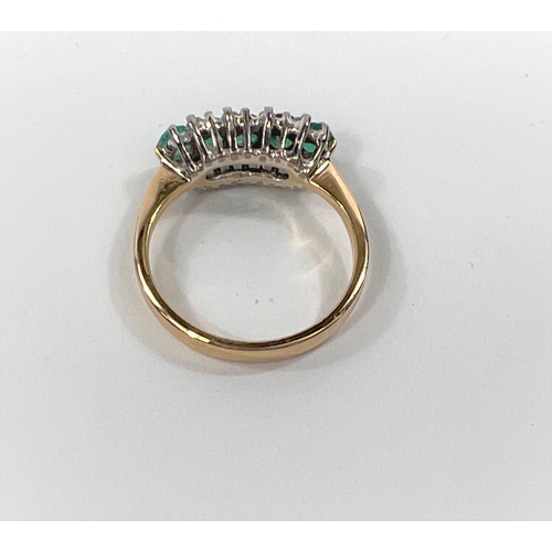 827 - An 18ct gold dress ring with five emeralds, with 8 diamond chips to the outside, 3.8gm