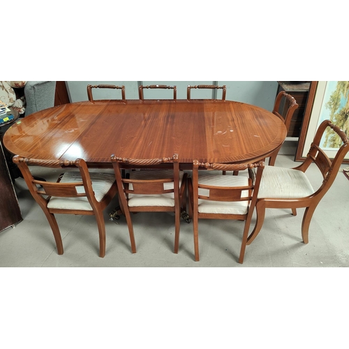 911 - A Regency style crossbanded mahogany dining suite comprising table with circular extending top, 3 sp... 