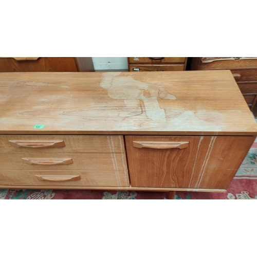 938 - A 1960's teak sideboard of 2 side cupboards and 3 central drawers, length 183cm