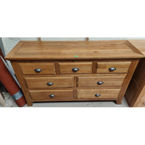 943 - A light oak chest of 7 drawers, width 136cm