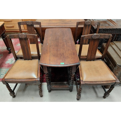 948 - An oak gate leg dining table with oval drop leaf top; 4 1930's oak dining chairs