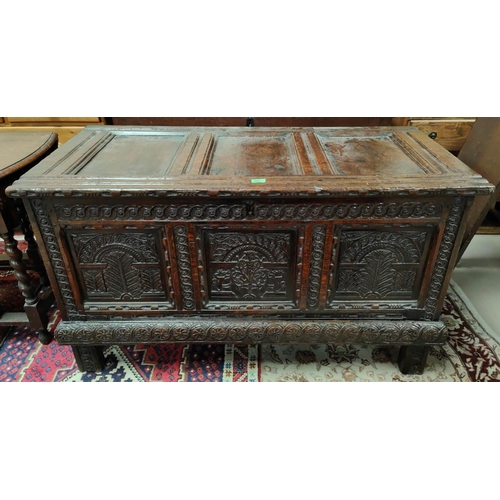 950 - A late 17th/early 18th century fine oak coffer, framed and panelled with extensive carved decoration... 