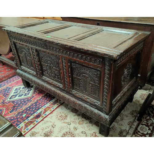 950 - A late 17th/early 18th century fine oak coffer, framed and panelled with extensive carved decoration... 