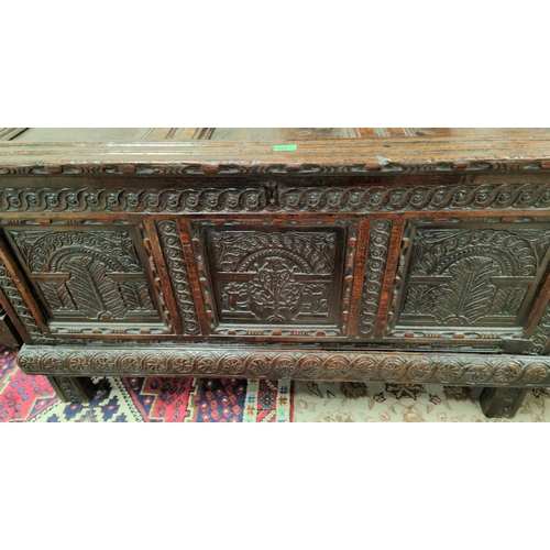 950 - A late 17th/early 18th century fine oak coffer, framed and panelled with extensive carved decoration... 