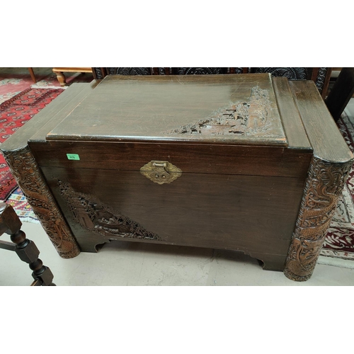 976 - An extensively carved camphor wood chest with brass fittings etc, length 104cm