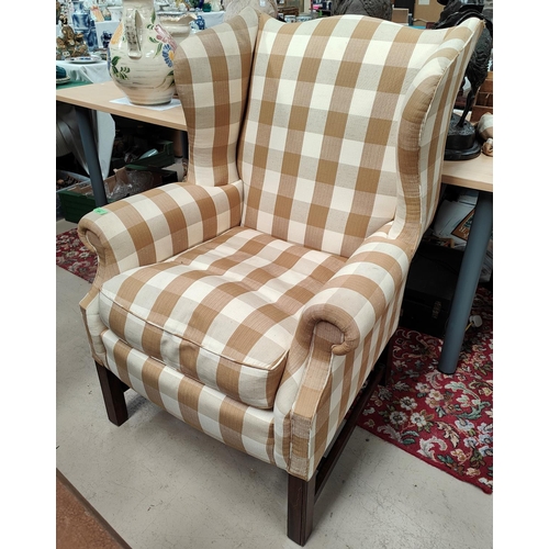 986 - A late19th/early 20th century armchair with later fawn and cream checked upholstery