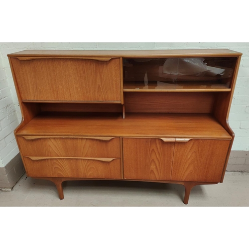 989 - A mid 20th teak low board with double cupboard, double drawers, pull down cocktail section and slidi... 