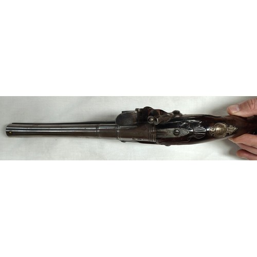 86 - A 19th century flintlock pistol, muzzle loading with white metal mounted decoration and relief carvi... 