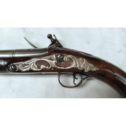 86 - A 19th century flintlock pistol, muzzle loading with white metal mounted decoration and relief carvi... 