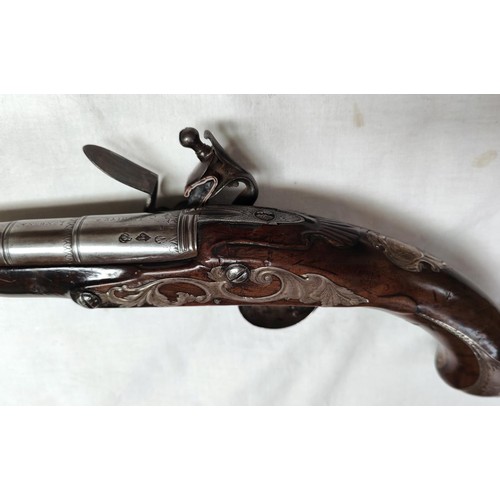 86 - A 19th century flintlock pistol, muzzle loading with white metal mounted decoration and relief carvi... 