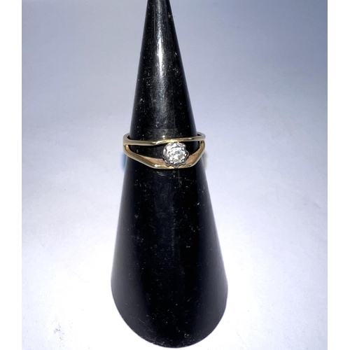 620A - An 18ct hallmarked gold split shank ring with elusion set solitaire, 3gms size N diamond approx 3mm ... 