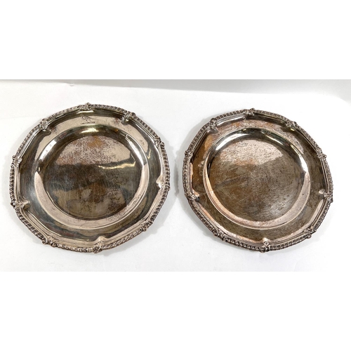 711 - A Georgian hallmarked silver pair of platters with gadroon and leaf wavy rims, crested, London 1761,...