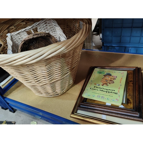 150 - Three wicker baskets; a vintage Paddington Bear book; a coloured etching; a watercolour