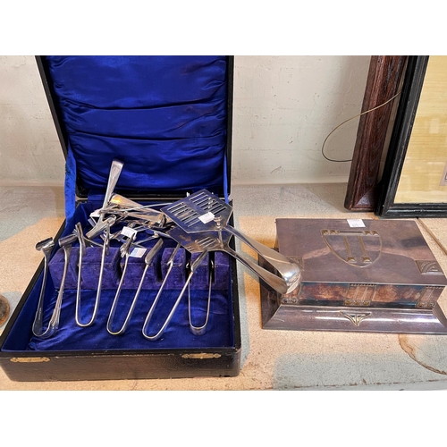 625 - A silver plated set of 12 asparagus tongs and server; a rectangular silver  plates 'Secessionist' bo... 