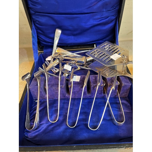 625 - A silver plated set of 12 asparagus tongs and server; a rectangular silver  plates 'Secessionist' bo... 